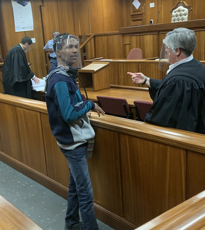 Walter Williams, 22, was convicted on Monday on charges of murder, attempted murder, illegal possession of a firearm and ammunition as well as aiding and abetting criminal gang activities. Here Williams confers with his legal aid-appointed defence advocate, Jodine Coertzen, in the Port Elizabeth high court.